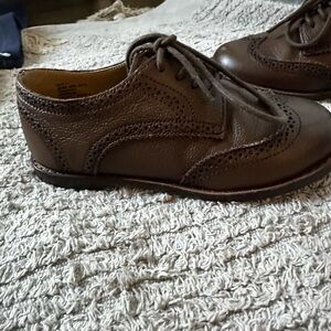 genuine leather wingtip shoes with tonal laces.
Leather.